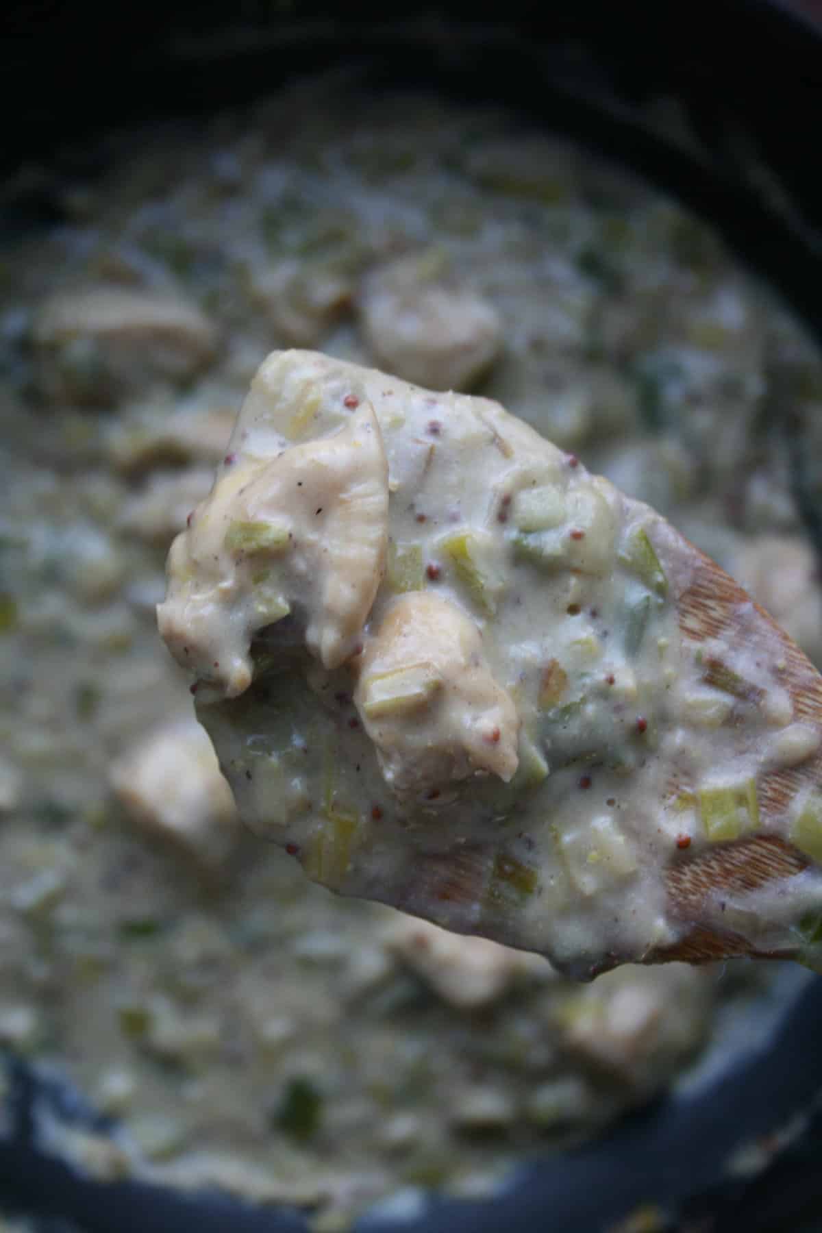 Close up of chicken leek and mustard pancake filling on a spatula.