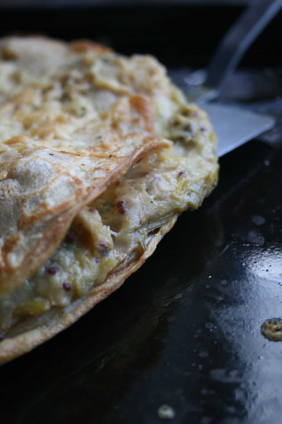 A close up showing the inside of the chicken leek and mustard crepe pancakes.