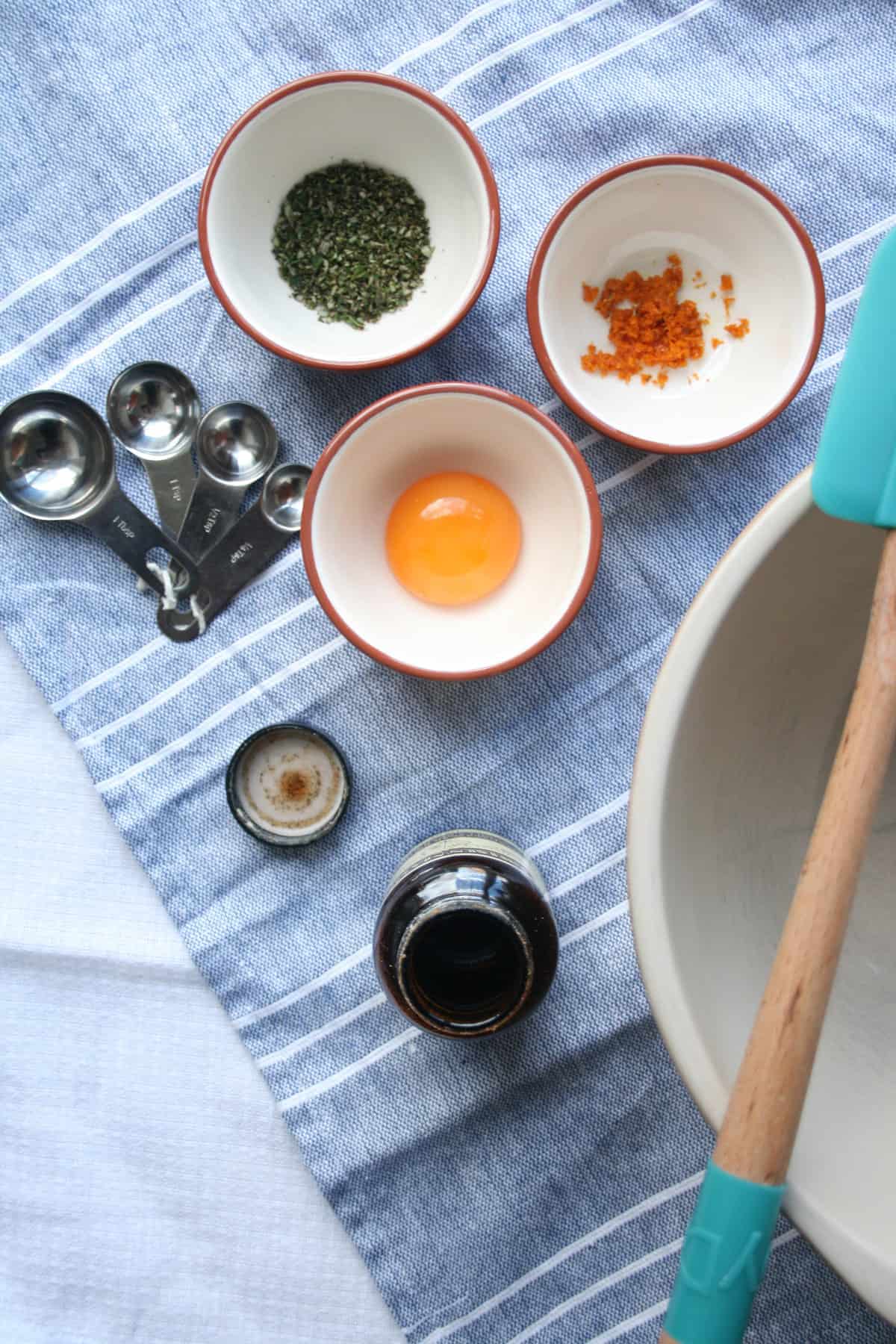 Ingredients in various bowls with a bowl and spatula to the side.