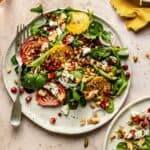 Beetroot feta walnut salad served on a plate with a fork and dukkah on top.