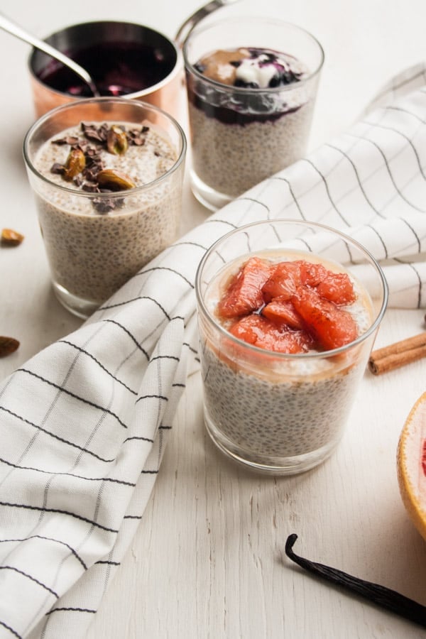 Two glasses of chia pudding in glasses with a napkin between them.
