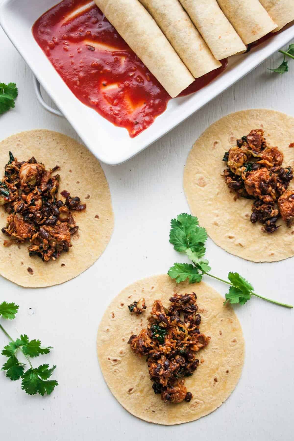 An array of brussels kale mixture on top of tortilla before being rolled up.