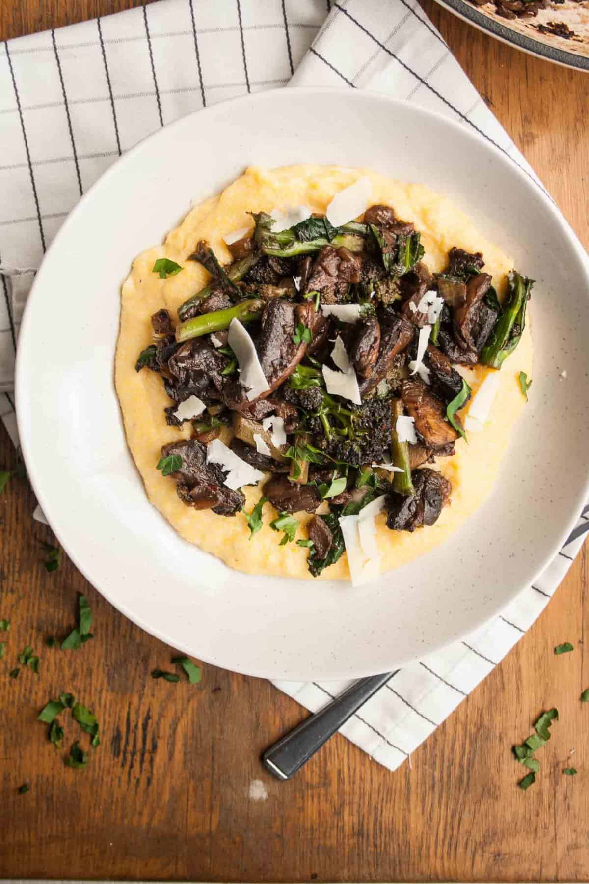 A plate of polenta with mushroom ragu on top.