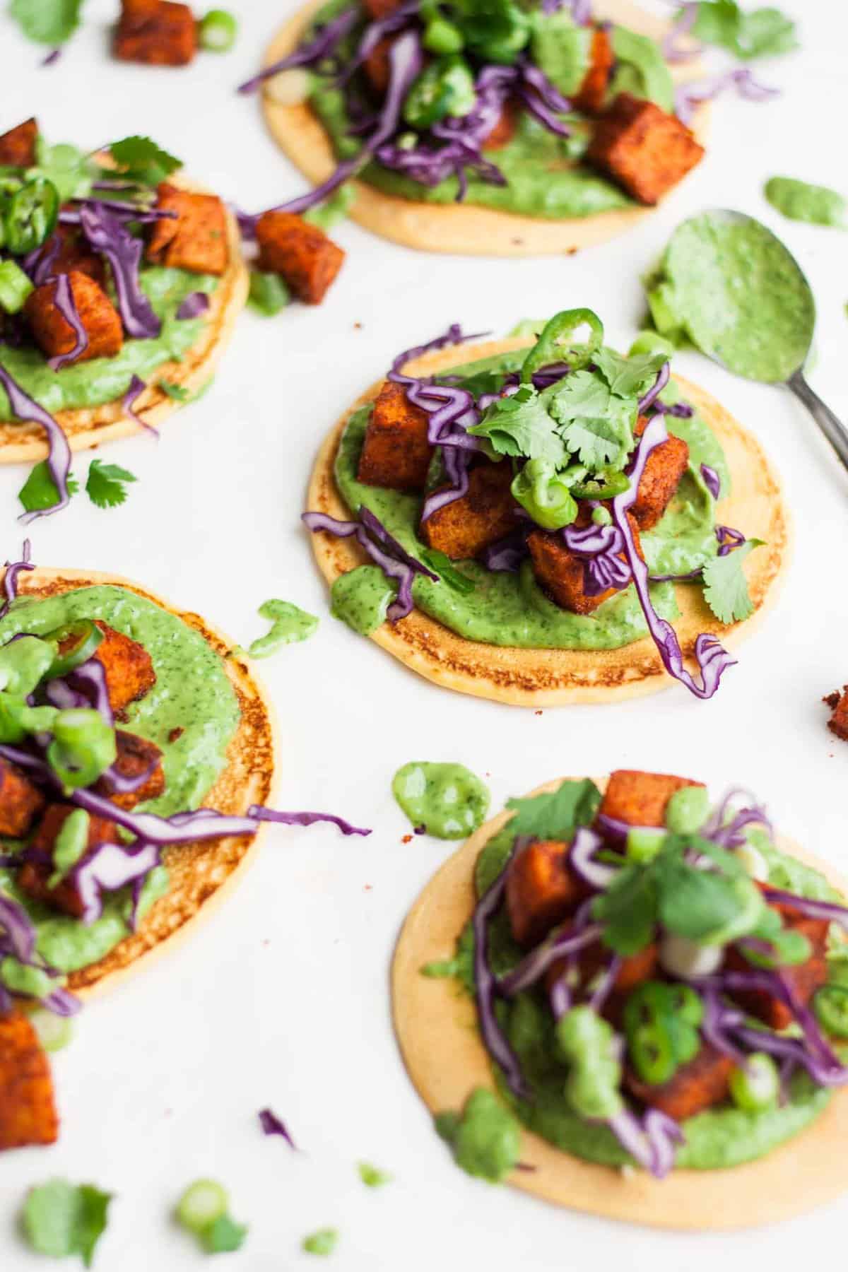 Vegan socca pizzas topped with sweet potato and cabbage.