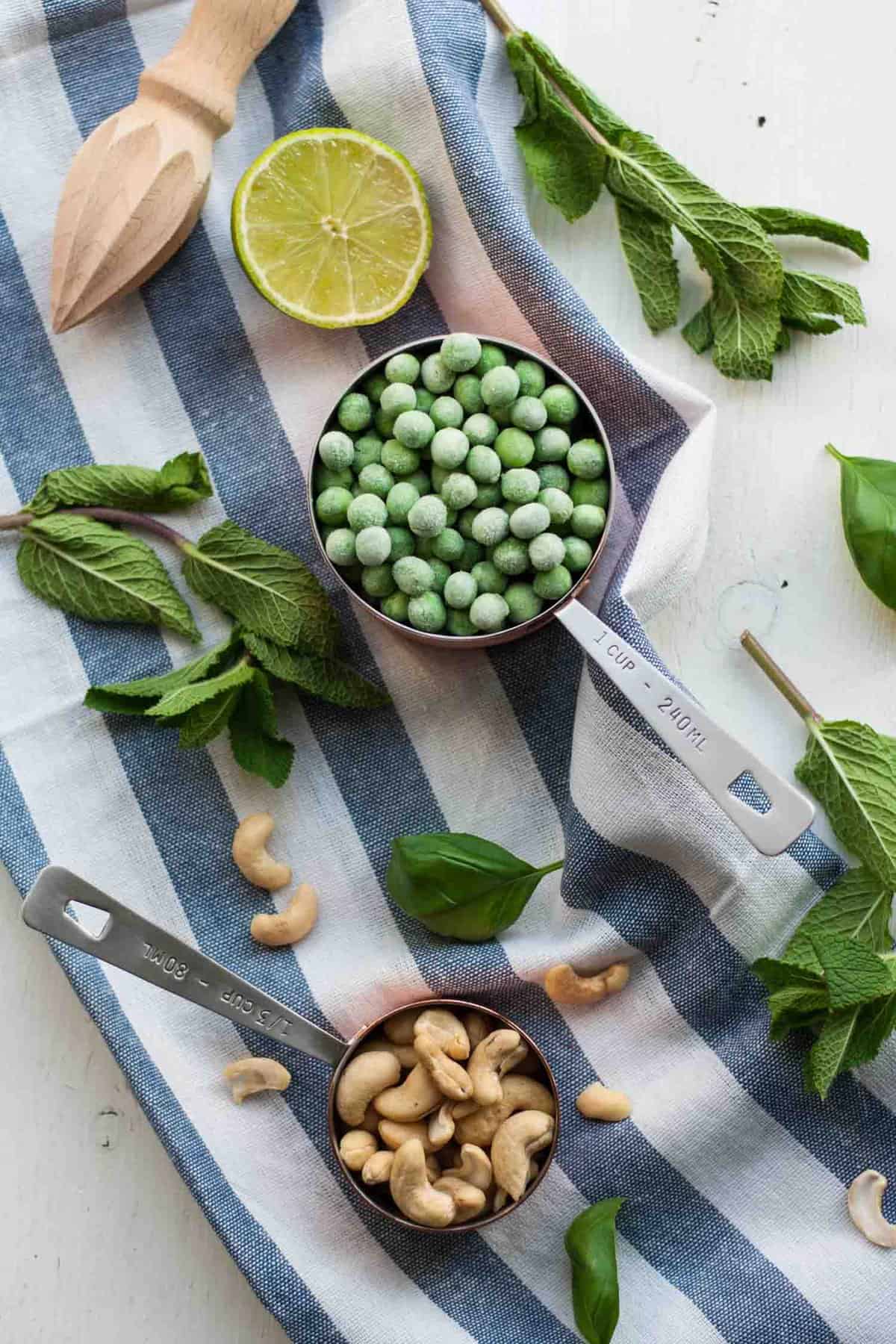 Peas, mint and cashews in an array at napkin.