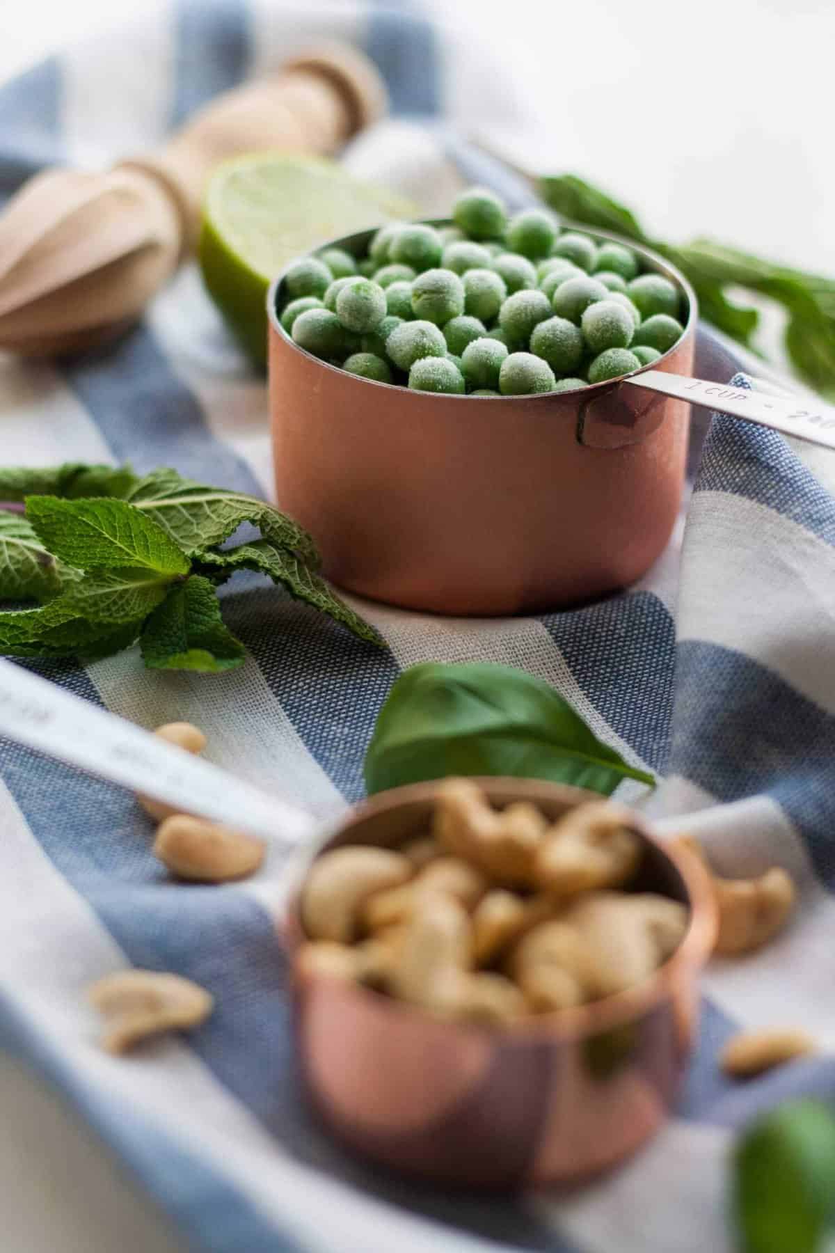 Frozen peas, mint and cashews on a napkin.