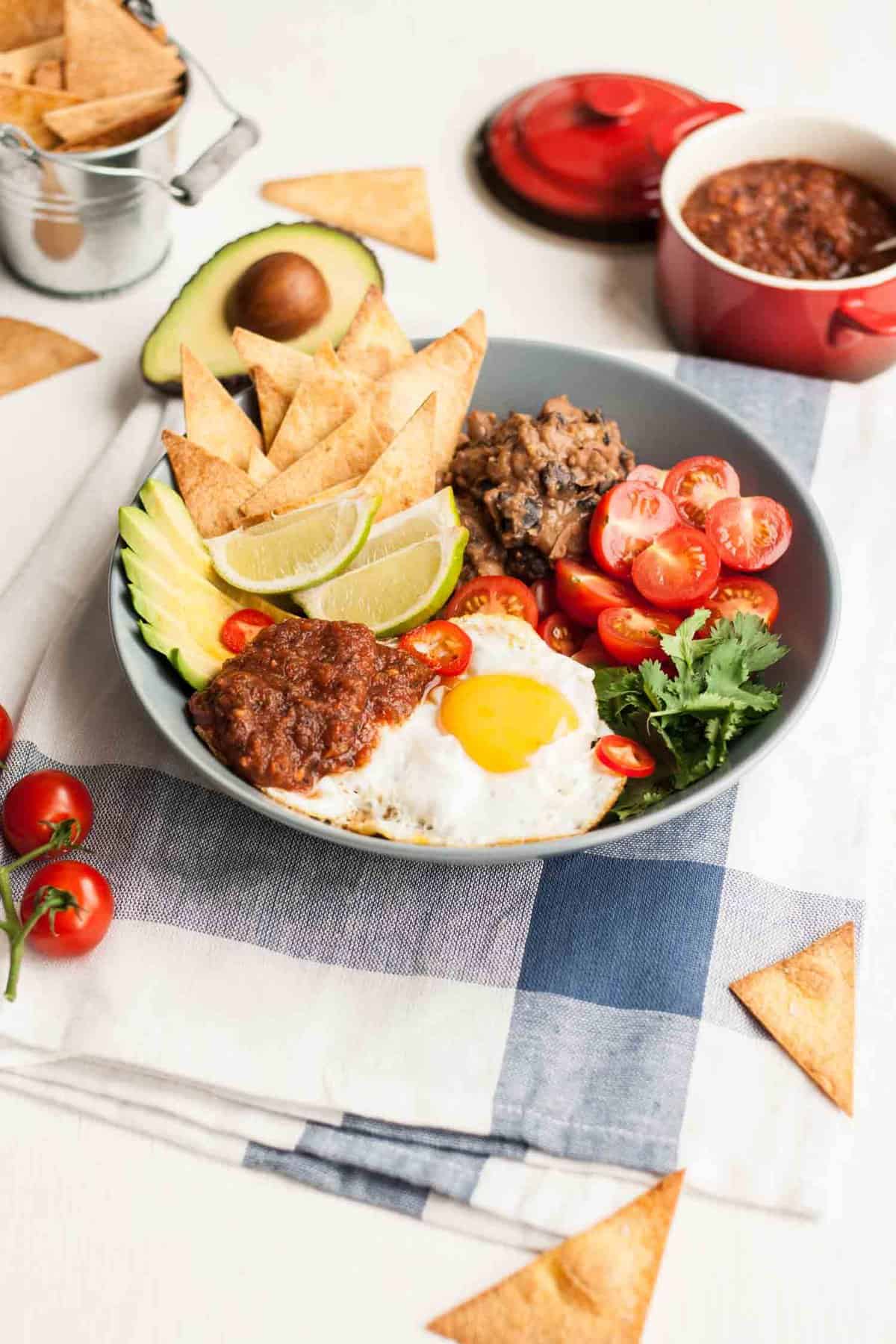A bowl with a variety of huevos rancheros ingredients. 