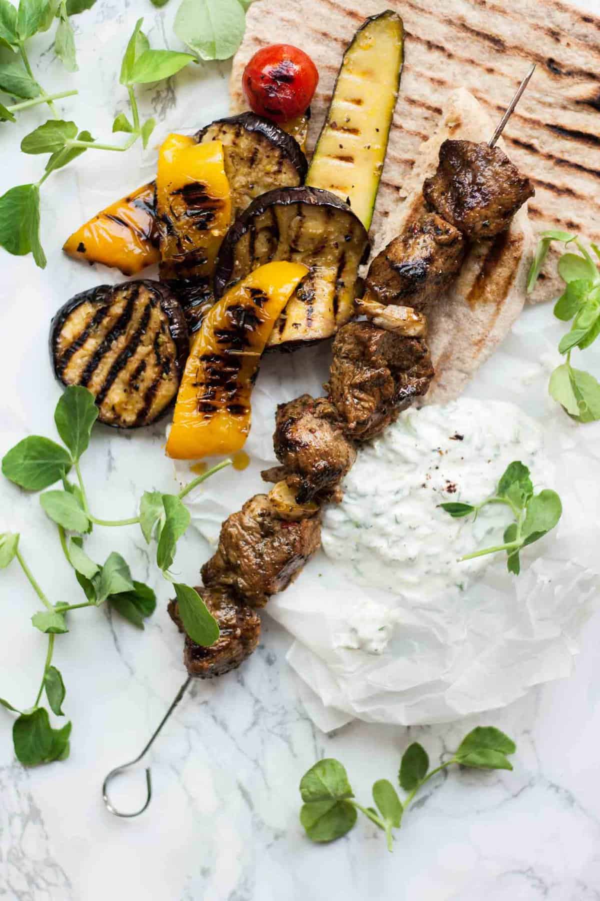 Lamb Souvlaki with Sumac Tzatziki - this simple grilled lamb dish is full of chargrilled flavour, perfect for eating in the garden on summer evenings. | eatloveeats.com
