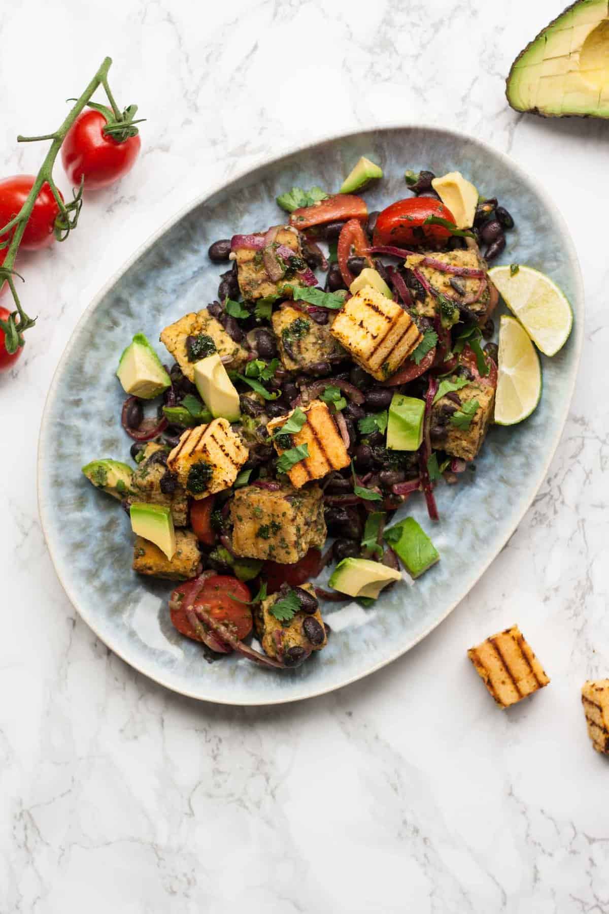 Mexican Panzanella Salad - this flavourful twist on the classic Italian bread salad is filled with black beans, avocado and cornbread and dressed with cilantro oil! | eatloveeats.com