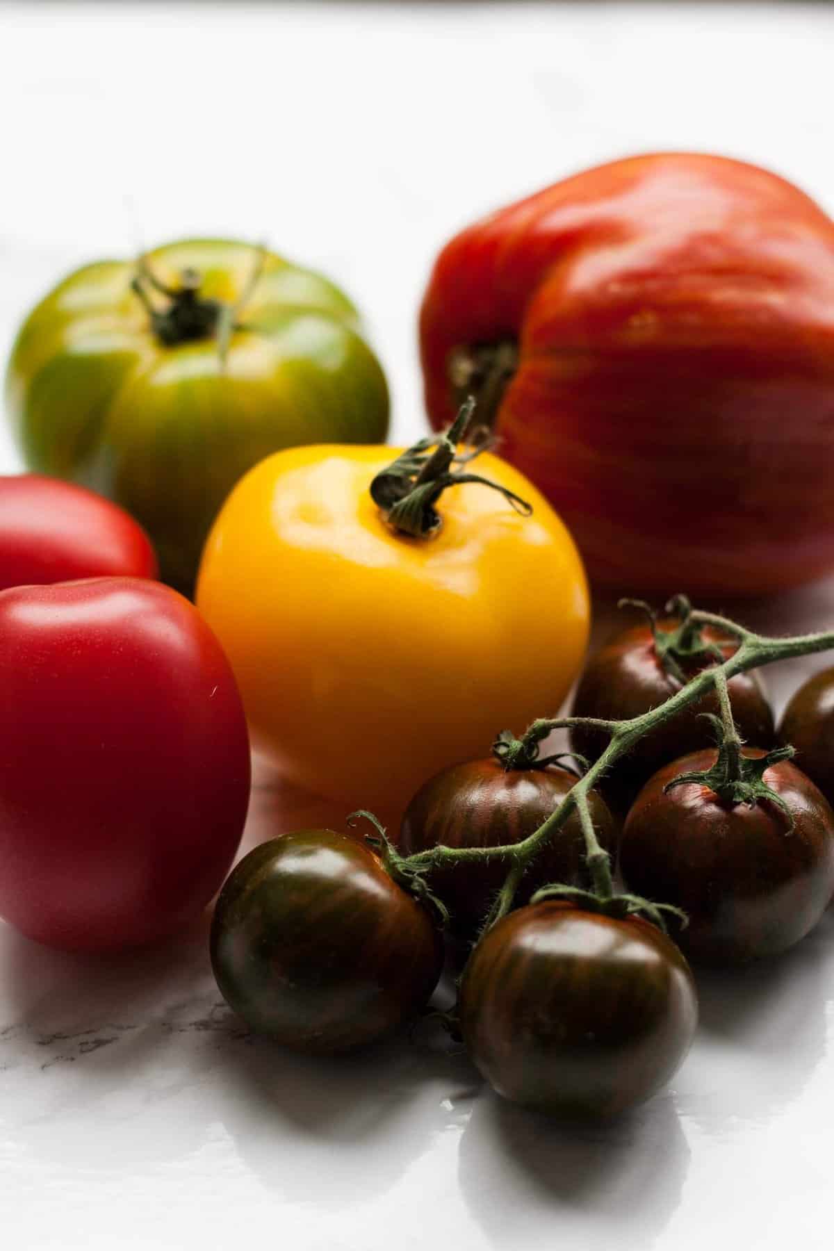 A array of colourful tomatoes, large and small.