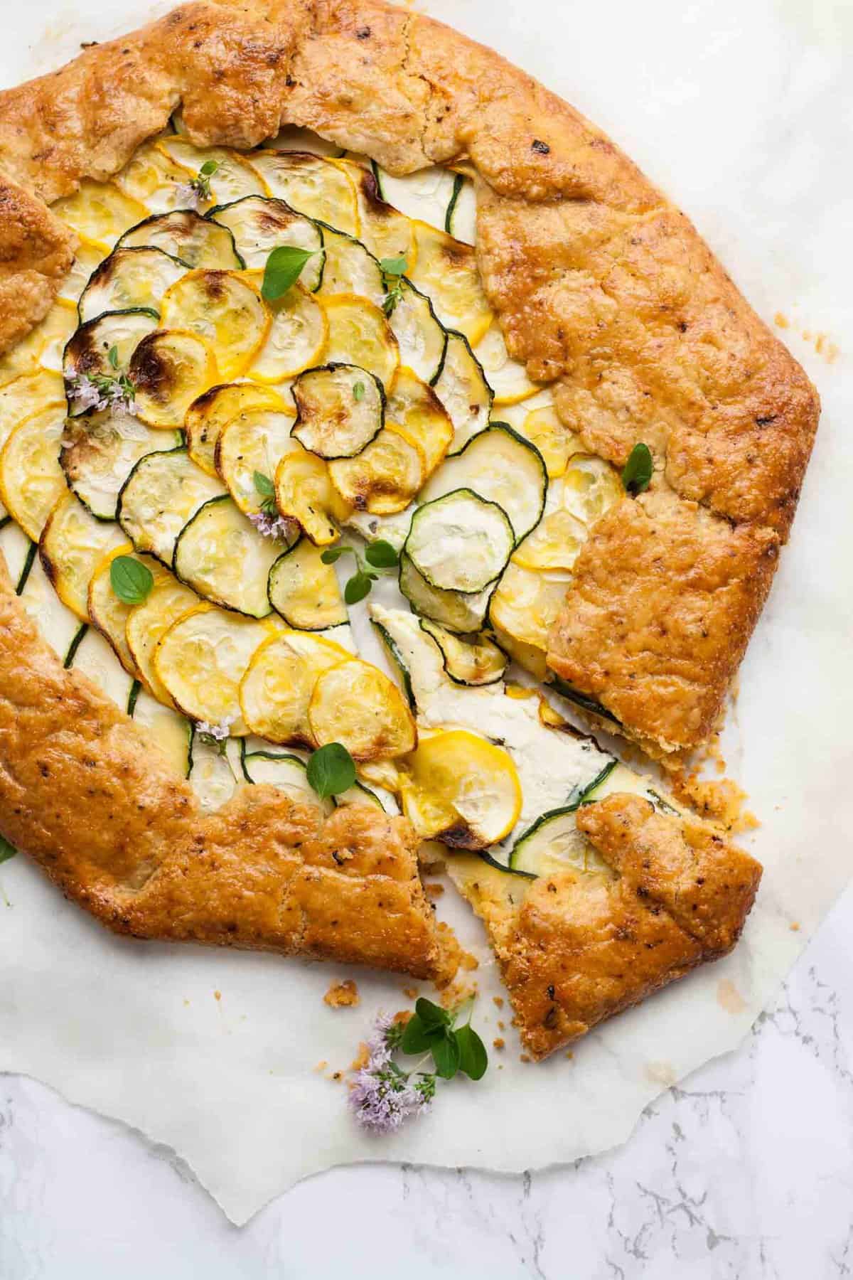 A slice taken from a whole galette being pulled out slightly.
