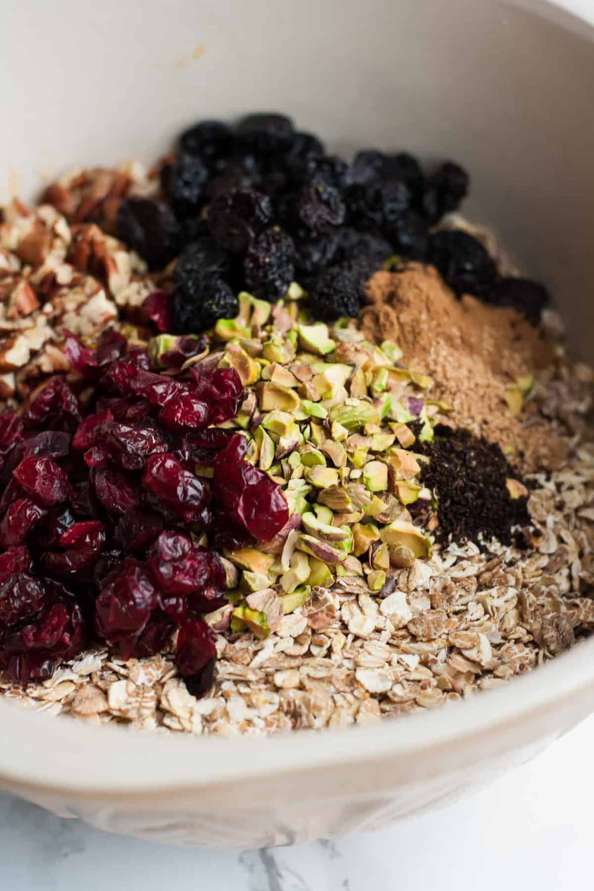 A mixing bowl with museli ingredients before being mixed together.