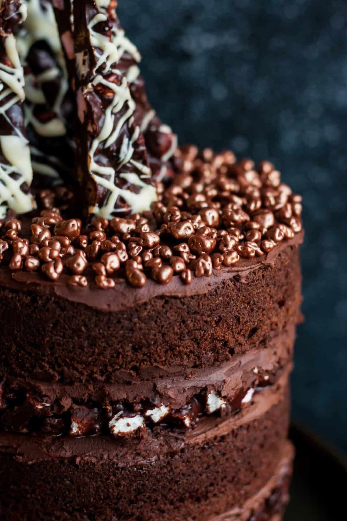 Chocolate toppings on top of a rocky road layer cake.