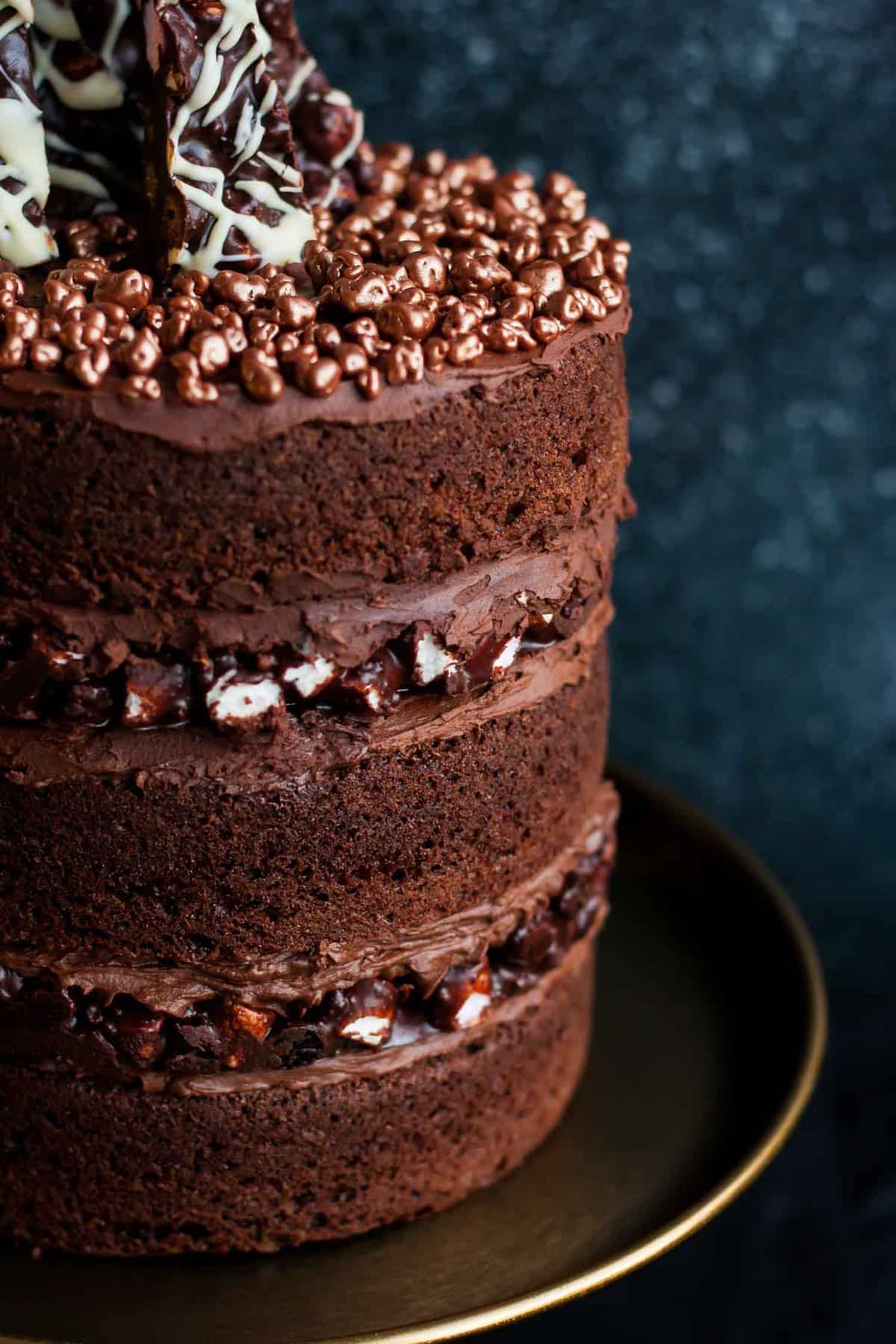 A close up of the chocolate ganache layers of a rocky road cake.