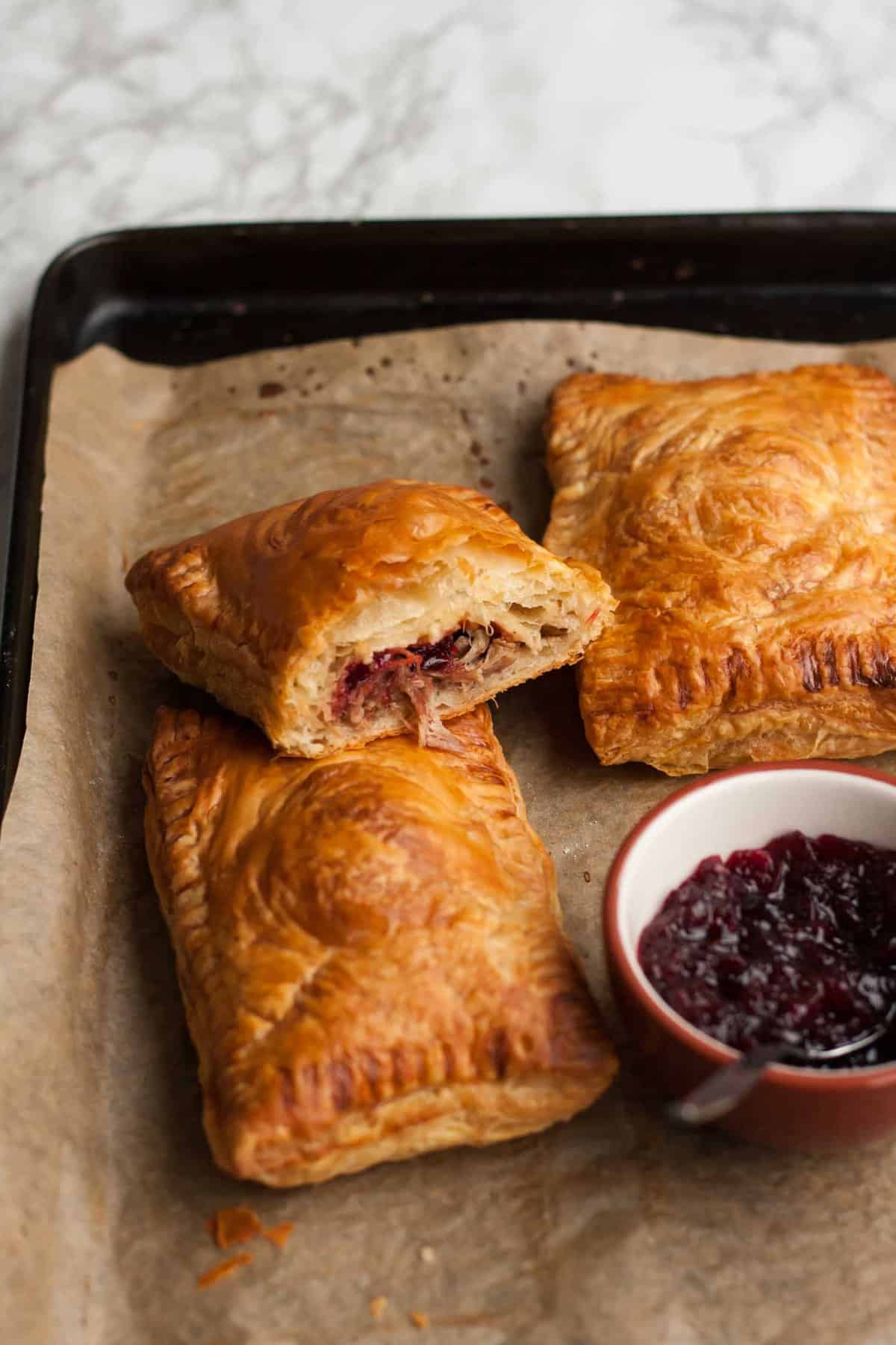 A lower angle showing the insides of the cut open pastry leant up against another pastry.