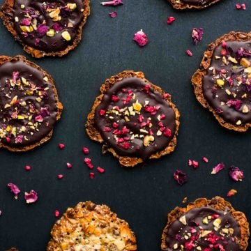Chocolate almond florentines on a slate background.