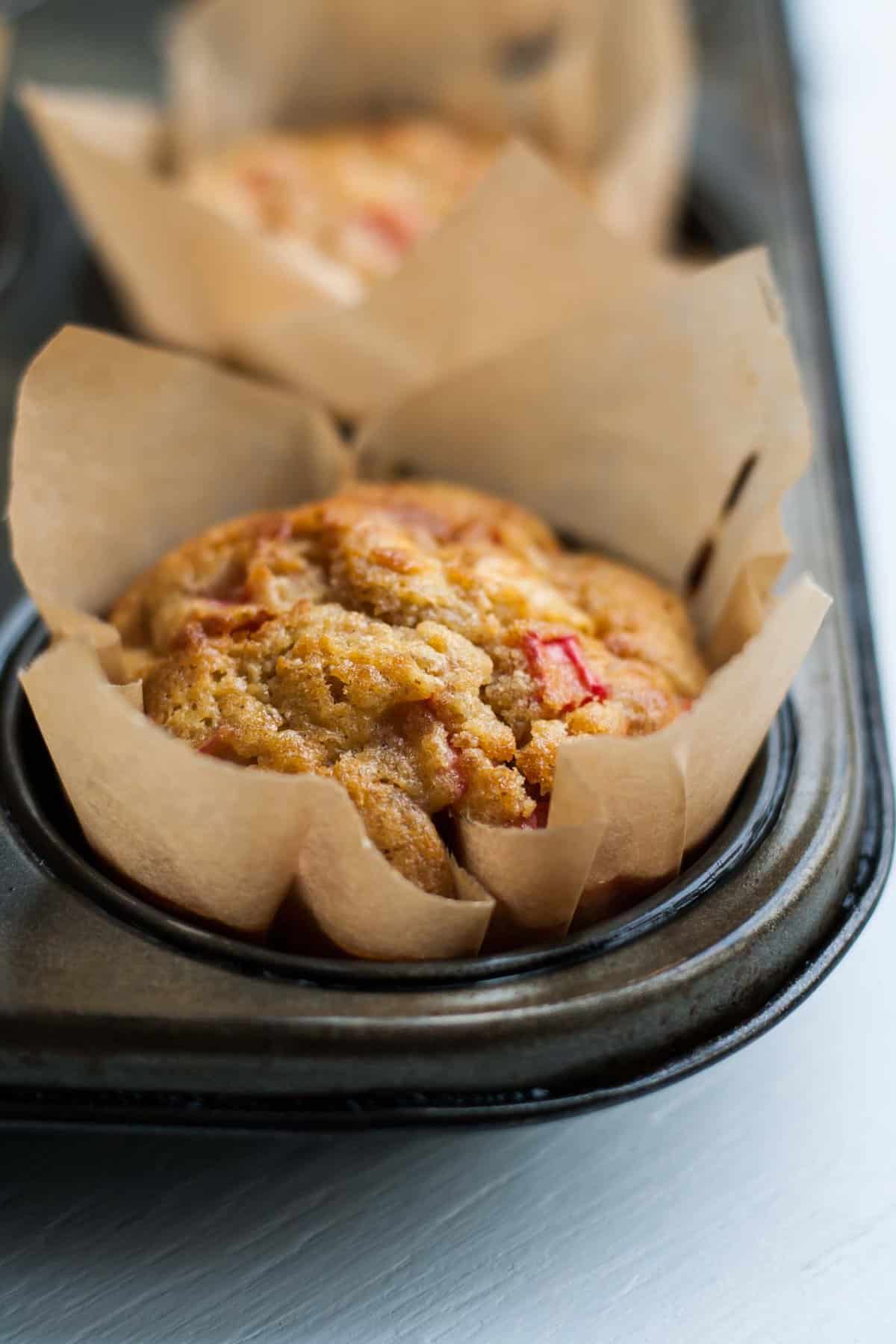 A close up of a baked muffin in a muffin tin.