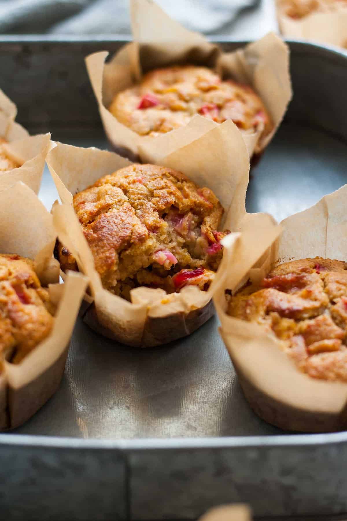 A close up of a broken open rhubarb muffin.