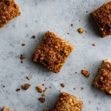 Rhubarb yoghurt cake squares on a grey background.