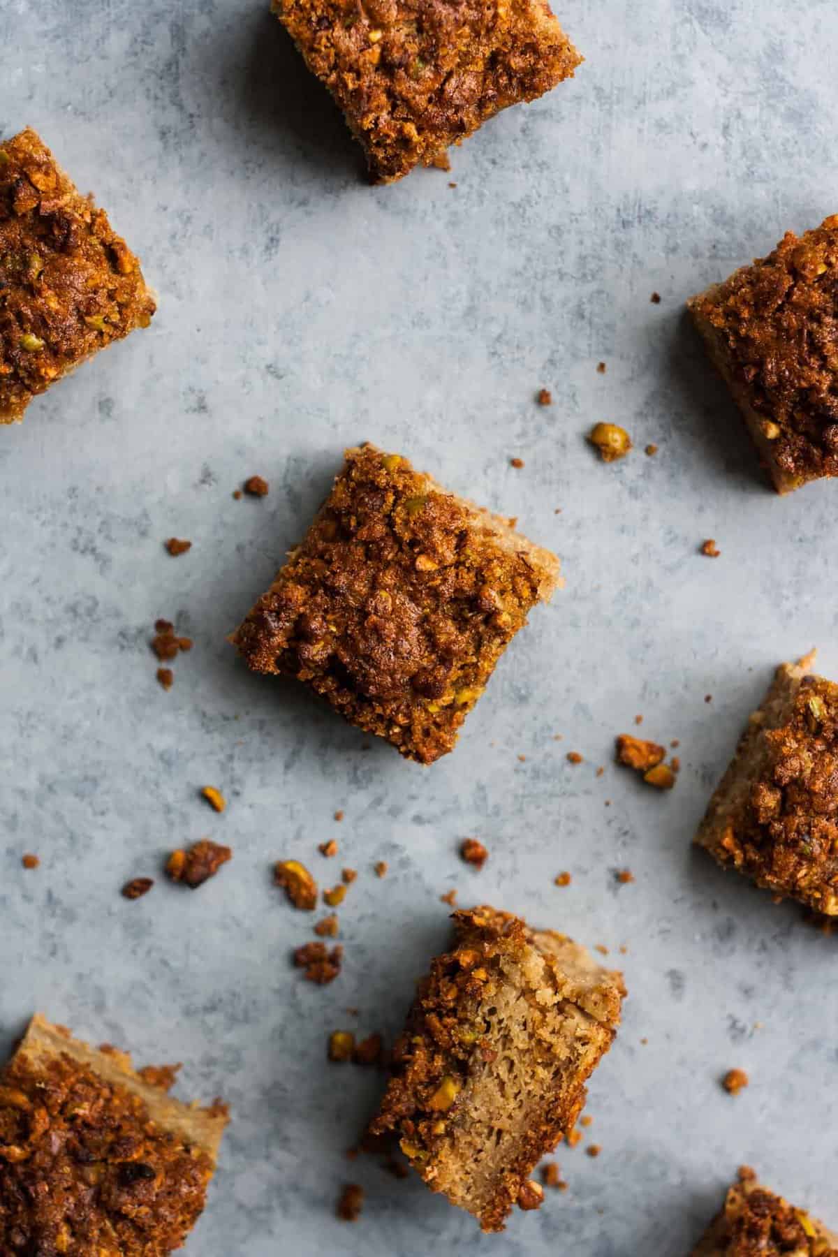 Rhubarb yoghurt cake squares on a grey background.