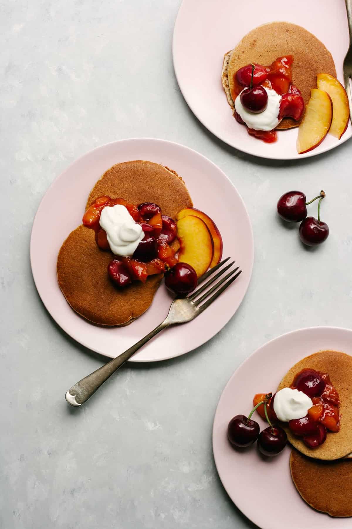 Almond butter pancakes with cherry nectarine compote on top.