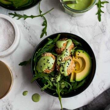 A bowl of sweet potato falafel with avocado and a sauce on top.