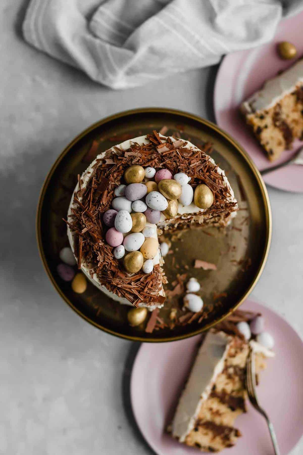 A chunk served out of an egg topped cake on a cake stand.