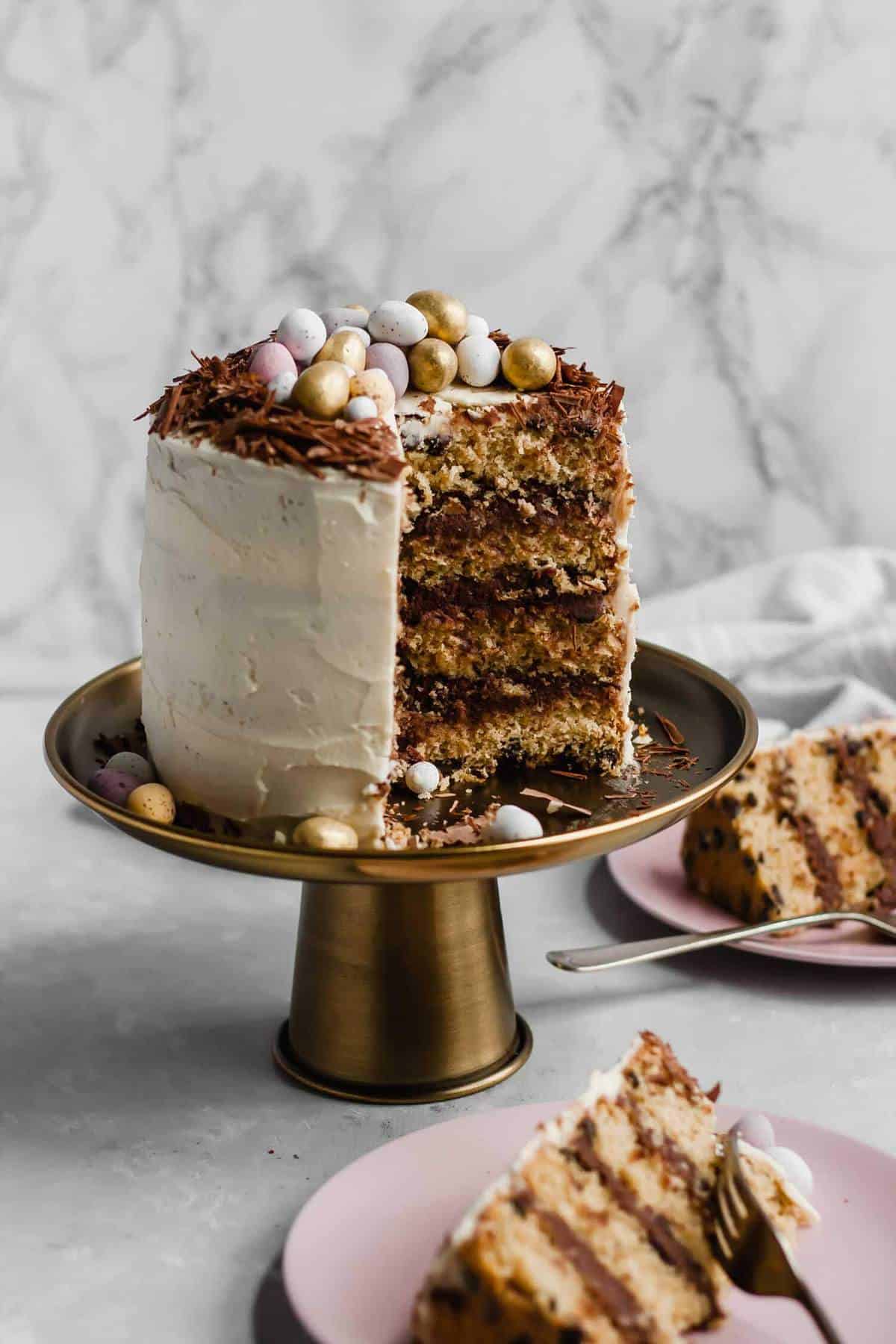 A cake on a cake stand cut open showing the insides. 