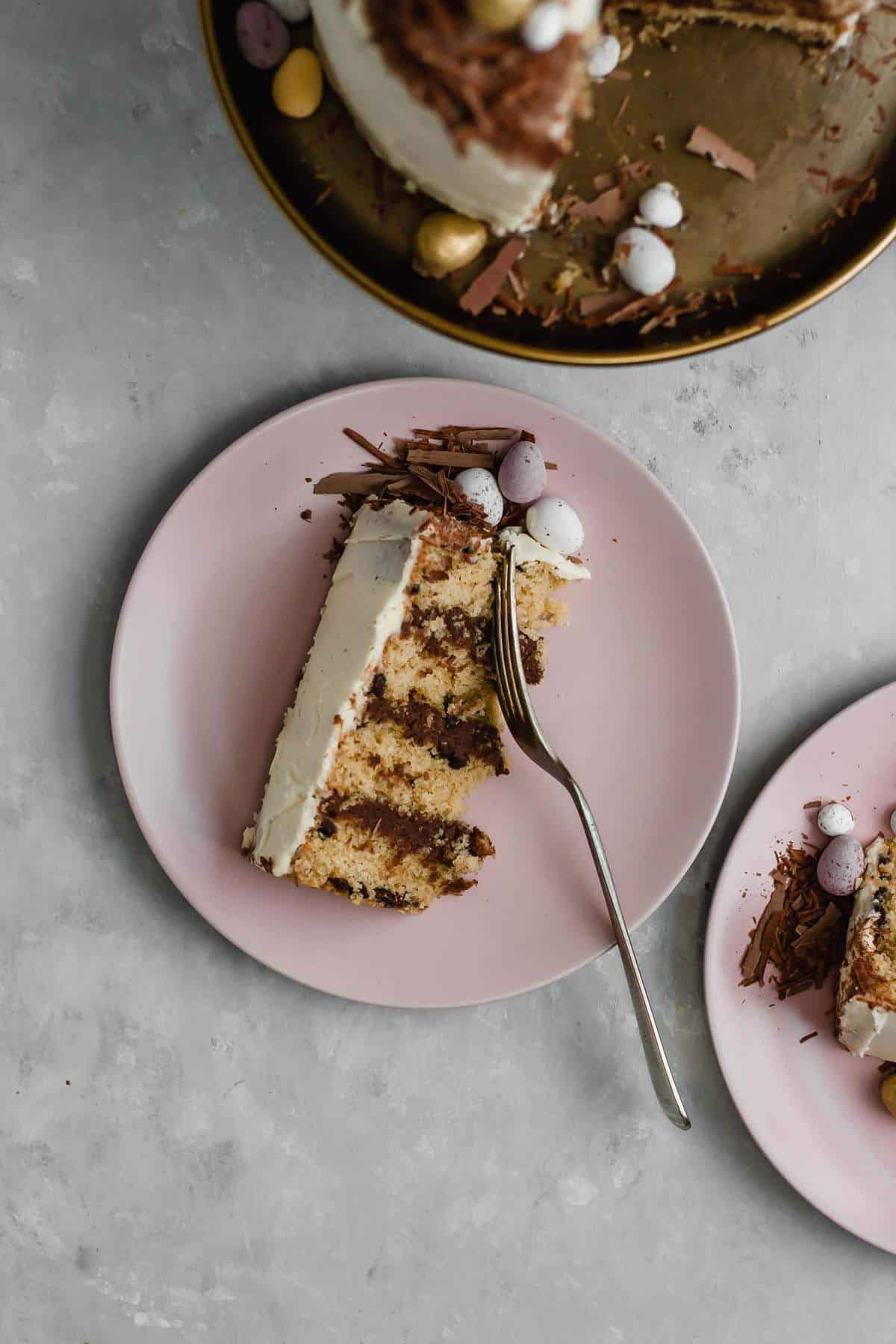 A slice of cake with a fork digging into it on a plate.