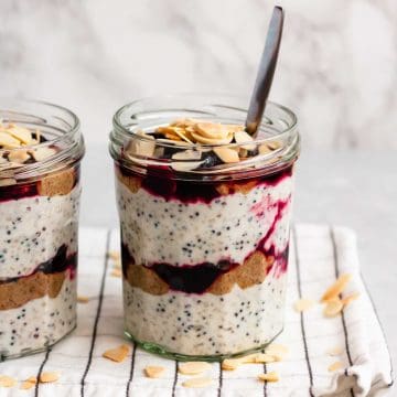 Cherry breakfast parfait in a jar with a spoon.