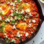 shakshuka with feta and chorizo in a skillet.