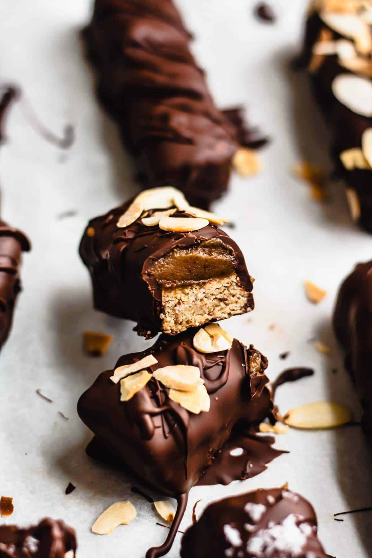 Vegan caramel bars cut in half showing the insides. 