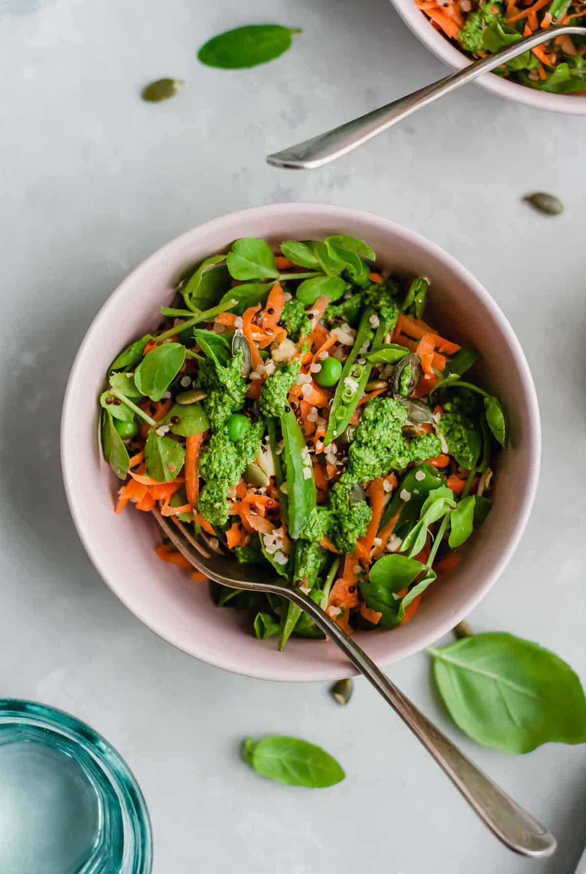 A bowl of quinoa salad with a fork. 