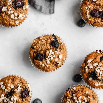 Vegan muffins on a grey background with blueberries.