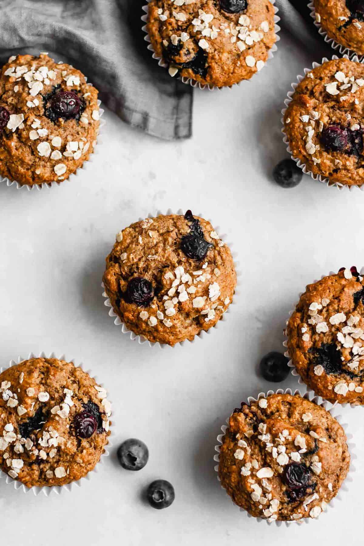 Vegan muffins on a grey background with blueberries.