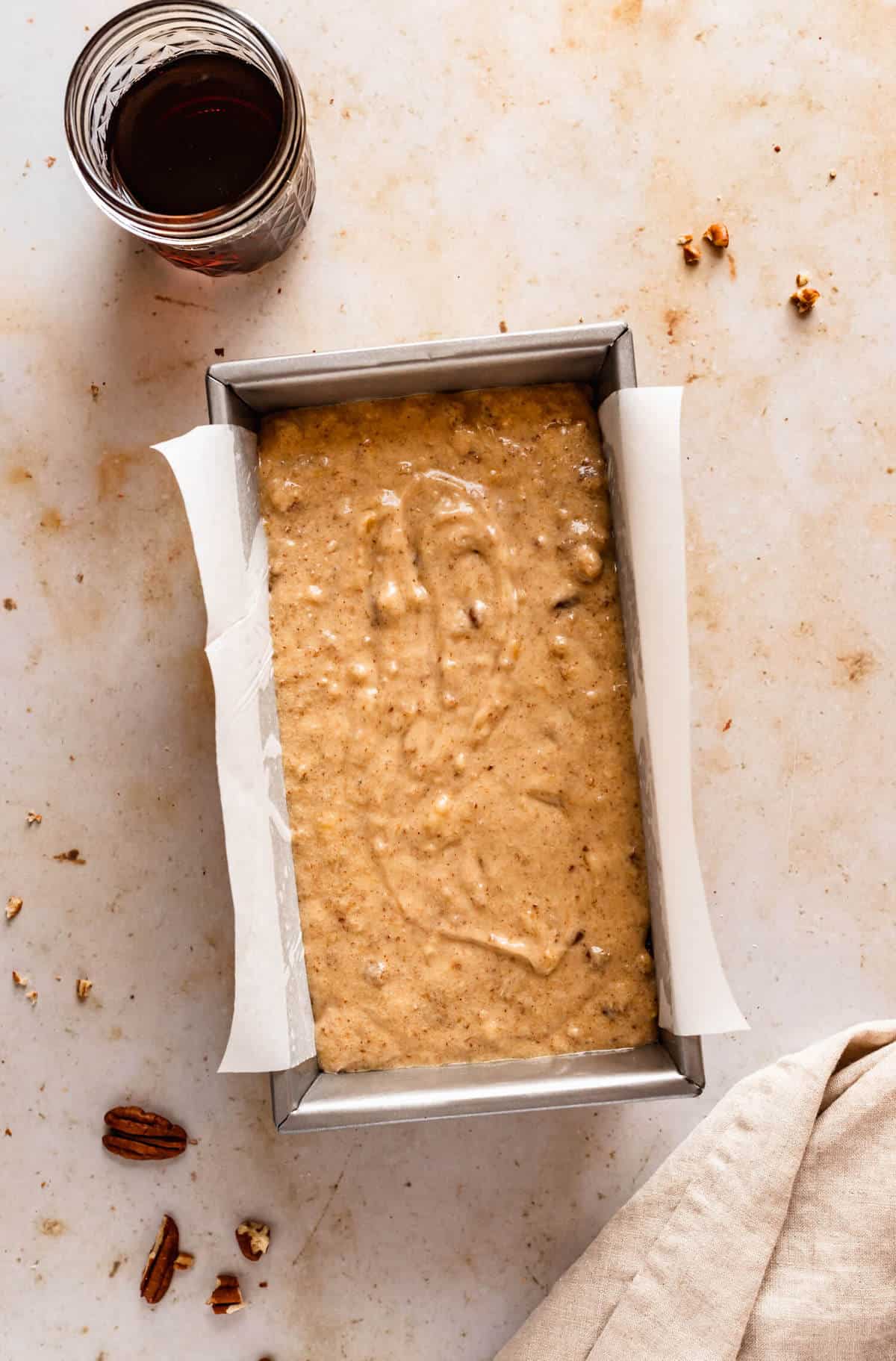 unbaked batter in a lined loaf pan