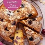 Cherry almond polenta cake cut into slices on a rack