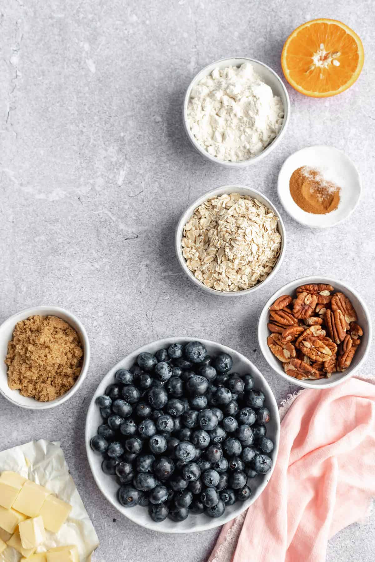 a variety of ingredients in bowls on a concrete surface