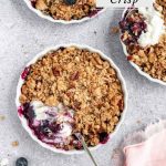 Blueberry Crisp with cream and a spoon
