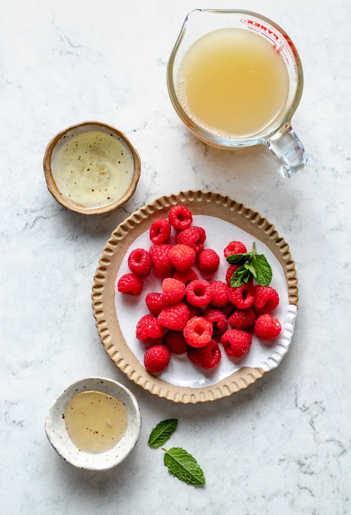 rapsberries, agave nectar, apple cider vinegar and apple juice in various jugs and bowls