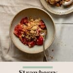 Strawberry crumble served up in a bowl and a plate with cream in a jug