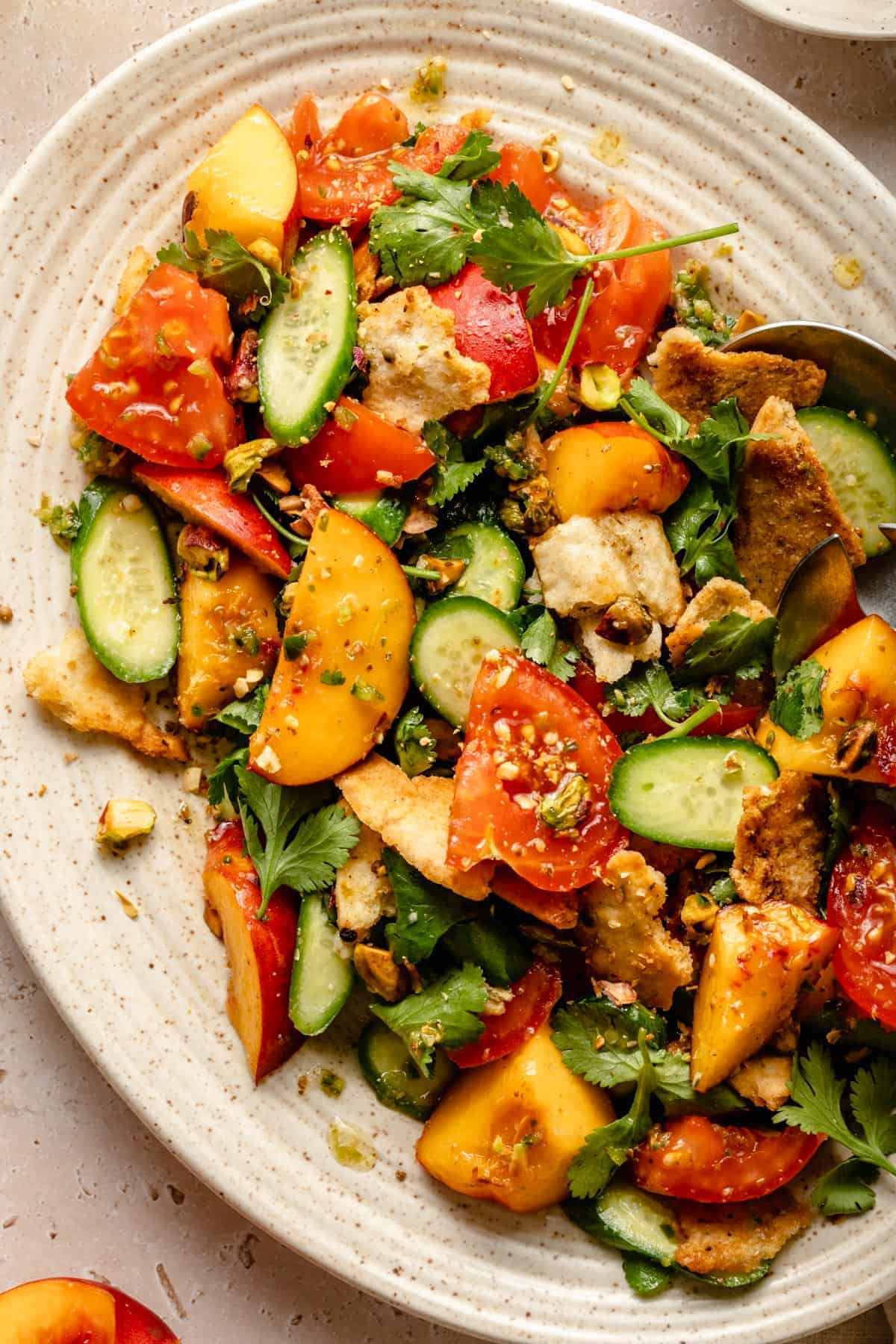 Final dressed salad on a platter with a spoon