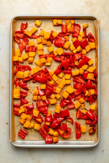 Tray of roasted butternut squash and red peppers.