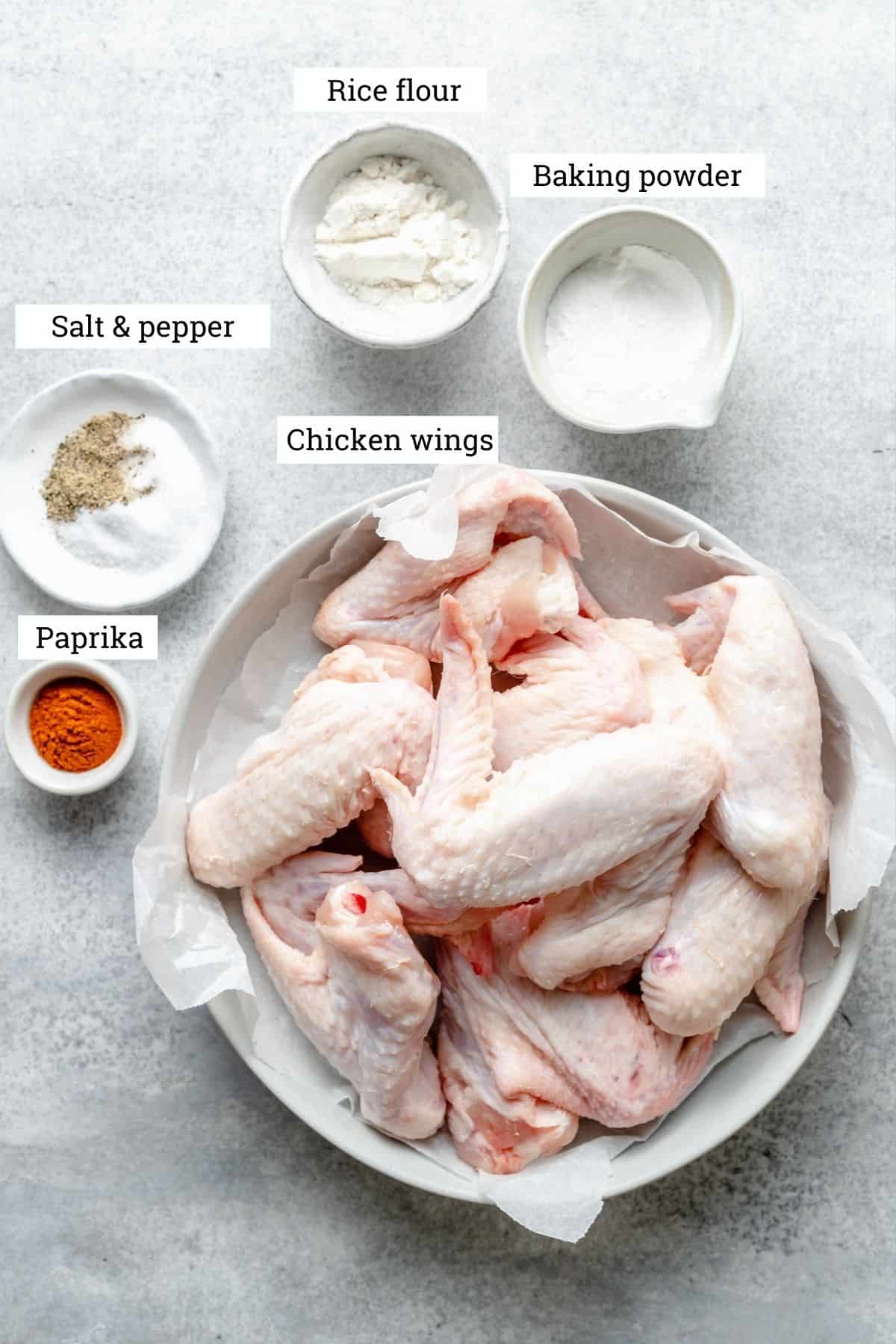 Ingredients for crispy baked chicken wings with baking powder, rice flour, salt & pepper and paprika.