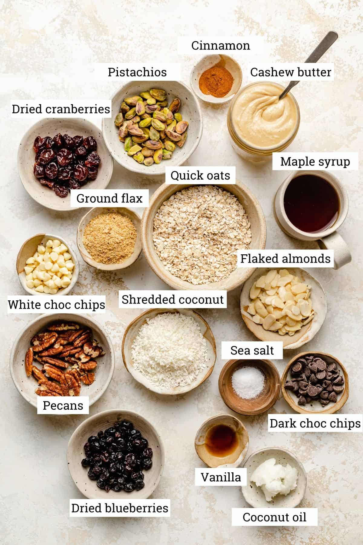 The ingredients for no bake granola bars in various bowls. 