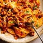 Easy Italian Sausage Ragu with Pappardelle on a bowl with a fork.