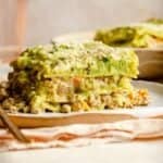 Creamy Broccoli Chicken Lasagna served on a plate with a golden fork.