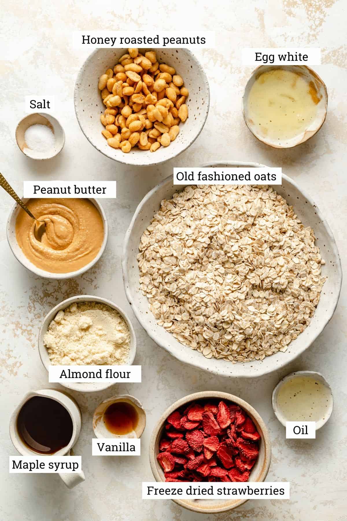 Ingredients for making peanut butter granola in various bowls.