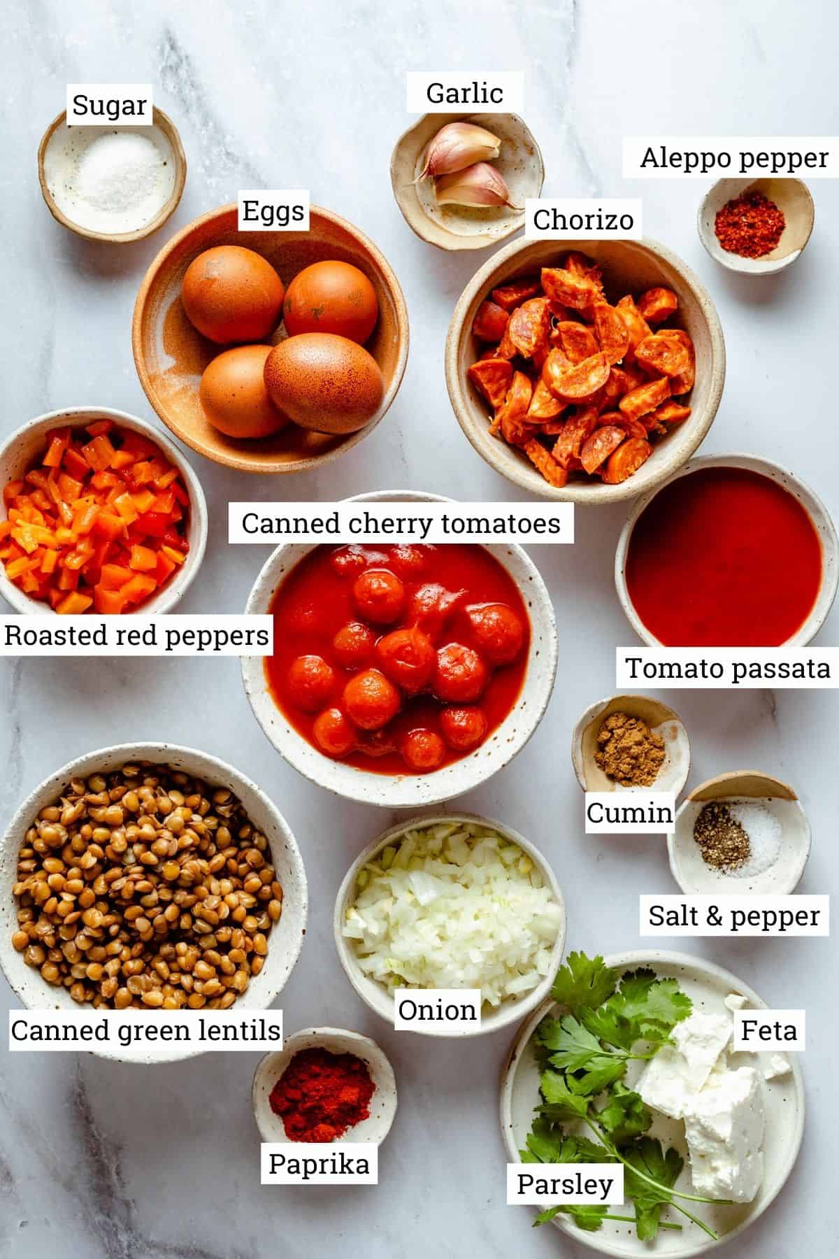 Ingredients to make shakshuka, including tomatoes, chorizo, lentils, peppers and eggs. 