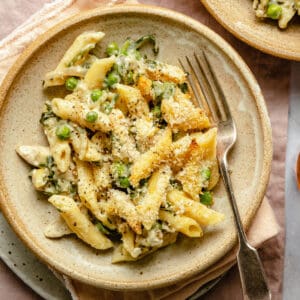 Creamy chicken pasta bake served on a plate with a fork showing the creamy sauce.